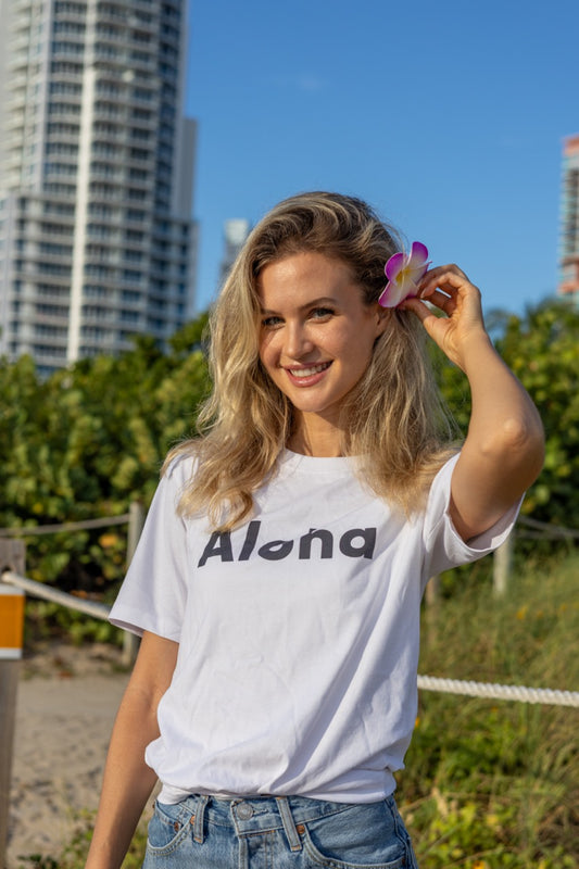 Hi Aloha Hawaiian Greet Tee by Happy interactions in white worn by Claire Schwegman on Miami Beach