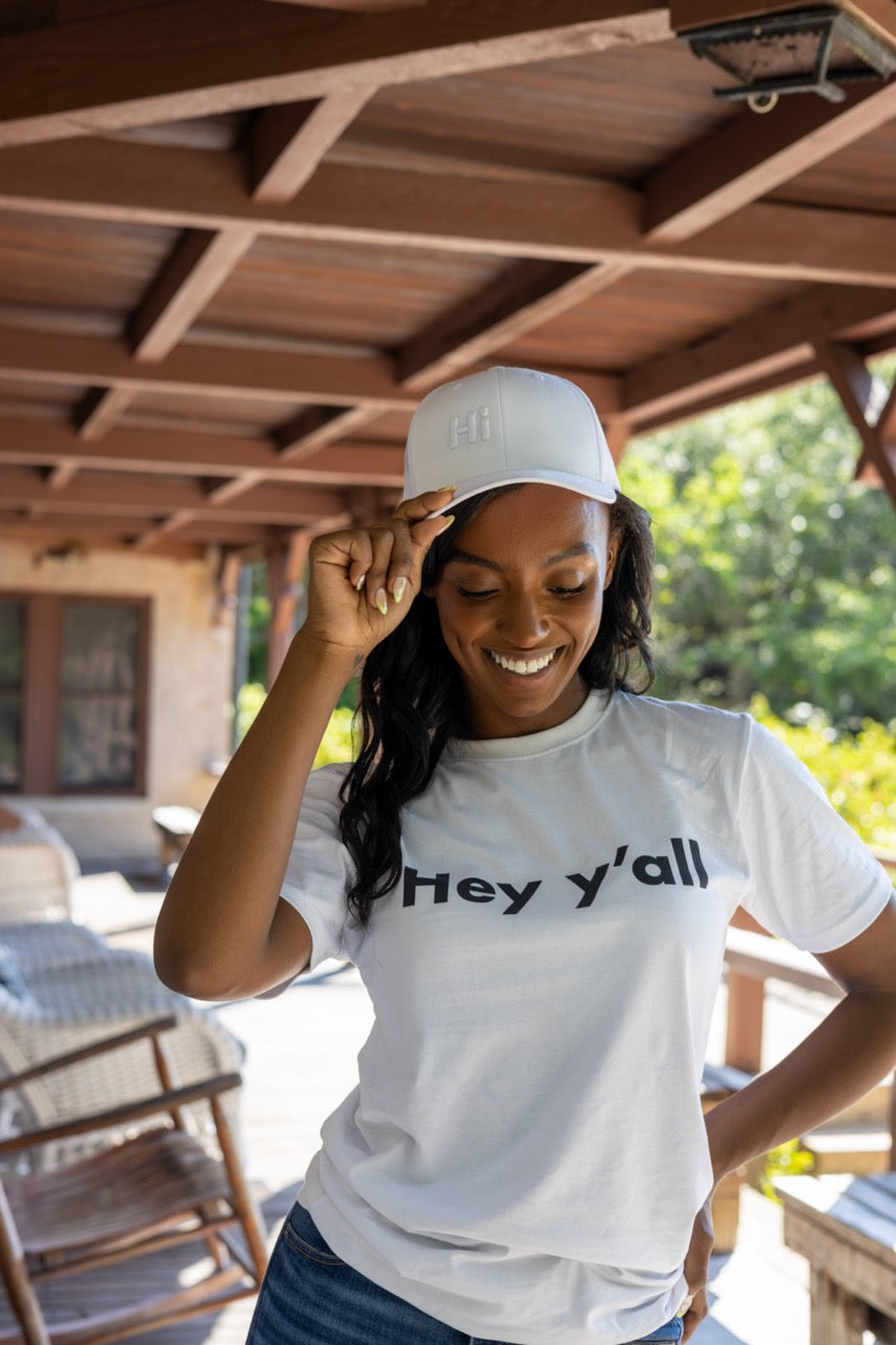 Hi Trucker Hat in white with white Hi logo modeled by Alyssa Ferguson