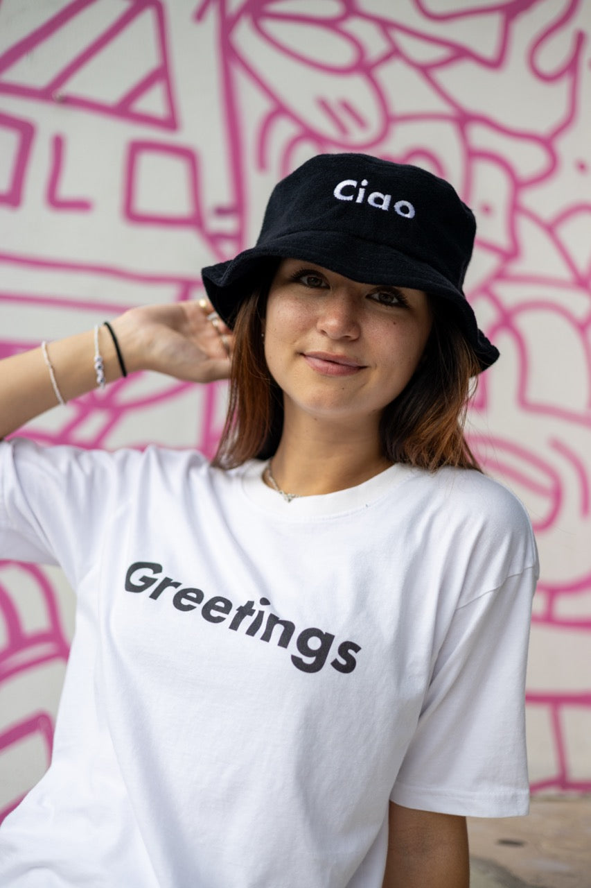 Hi Ciao Terry Towel Beach Bucket Hat in black modeled by Dani Kott in Wynwood, Miami wearing the Greetings T shirt