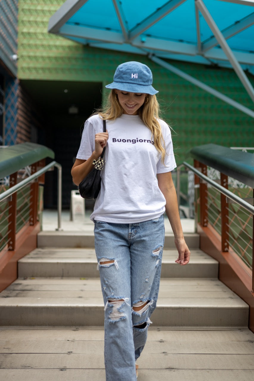Alia Buoniello models the Hi Happy interactions Denim Bucket Hat in Light Blue Denim at the Miami Design District