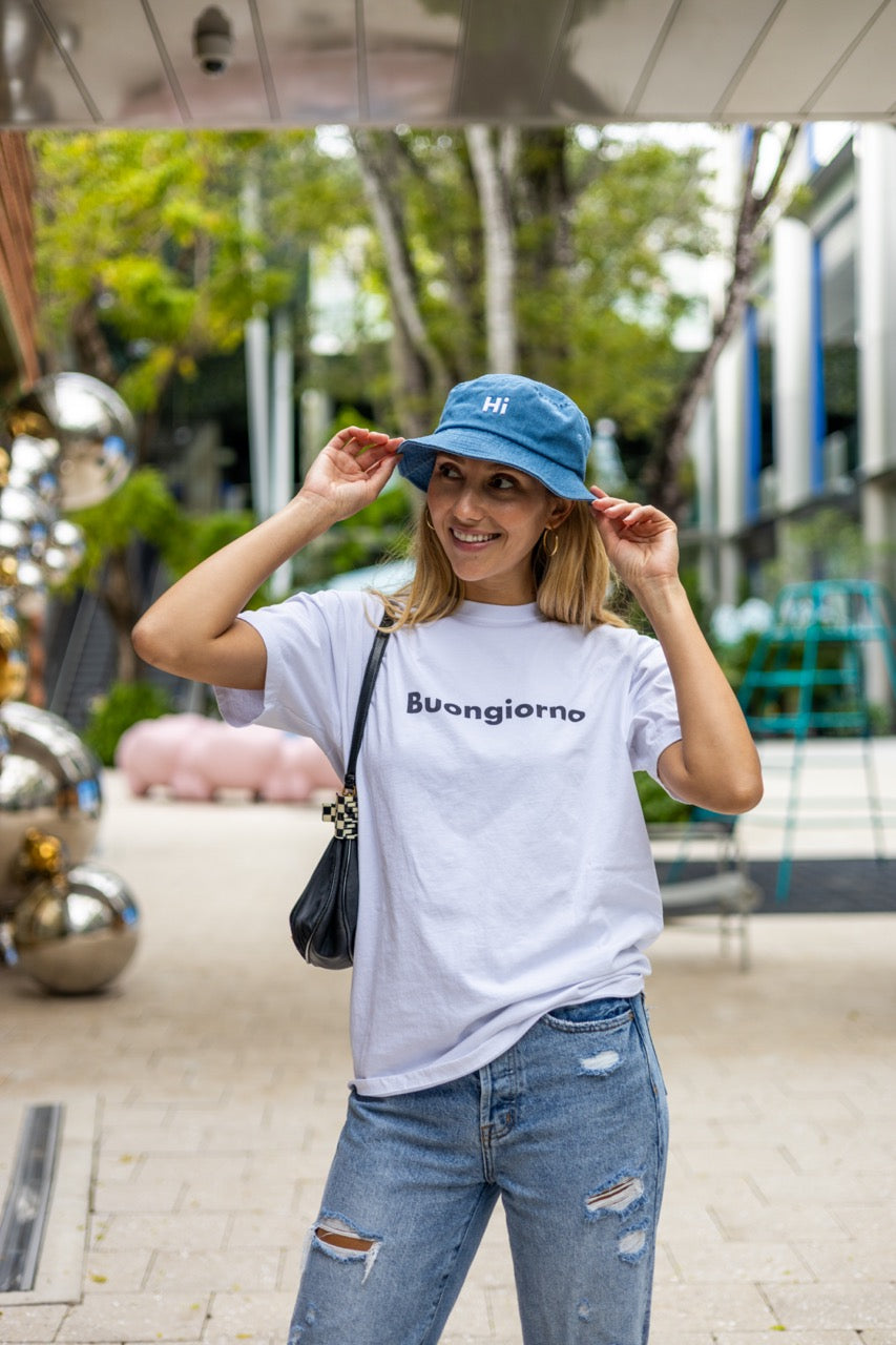Alia Buoniello models the Hi Happy interactions Denim Bucket Hat in Blue Denim at the Miami Design District