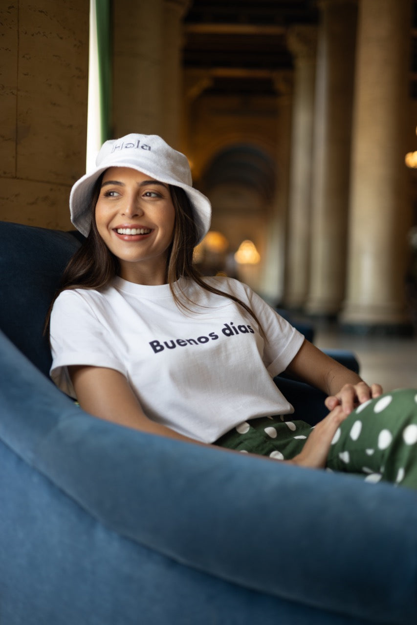 Hi Buenos Dias Spanish Good day Greeting T shirt in white, modeled by Rosa Abi at the Biltmore in Coral Gables Florida