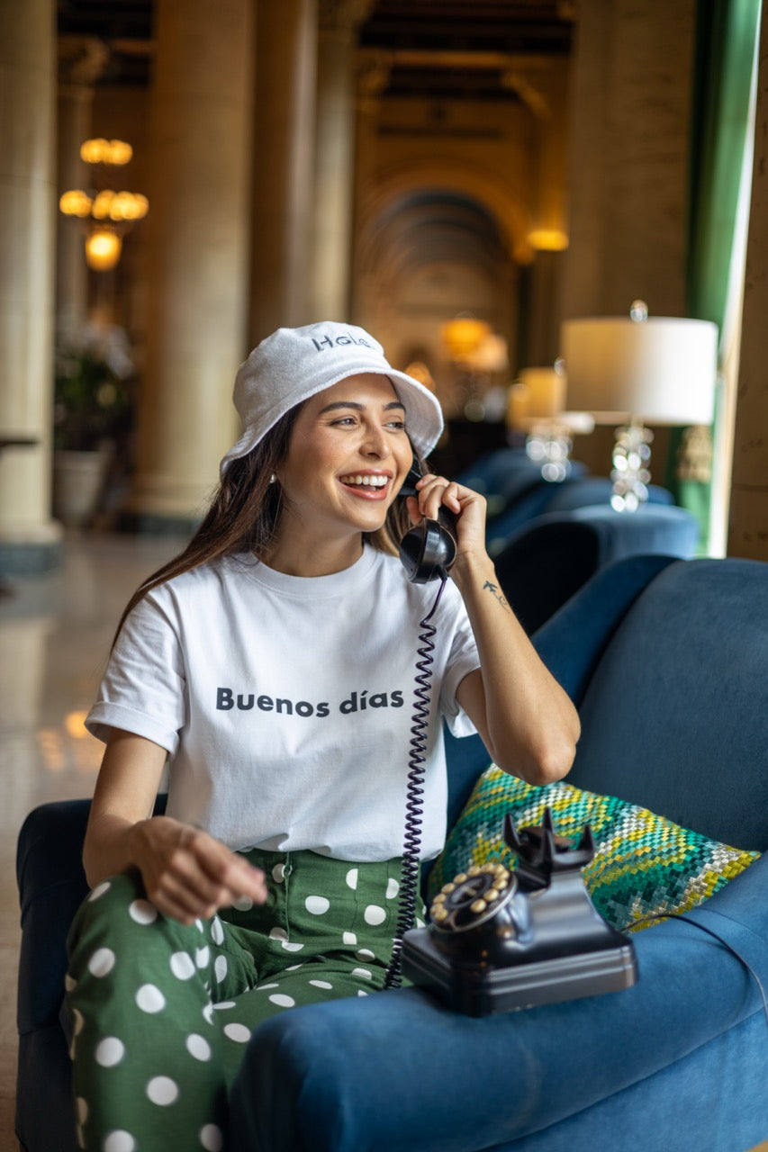 Hi Buenos Dias Spanish Good day Greeting T shirt in white, modeled by Rosa Abi at the Biltmore in Coral Gables Florida