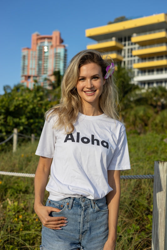 Hi Aloha Hawaiian Greet Tee by Happy interactions in white worn by Claire Schwegman on Miami Beach