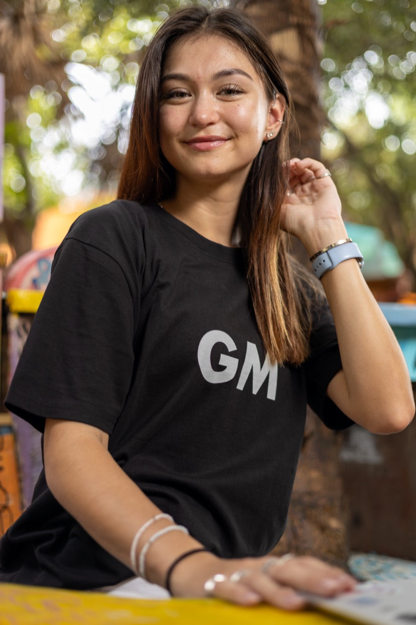 Hi GM Good Morning Internet Lingo Greeting T shirt in black, modeled by Dani Kott in Wynwood, Miami