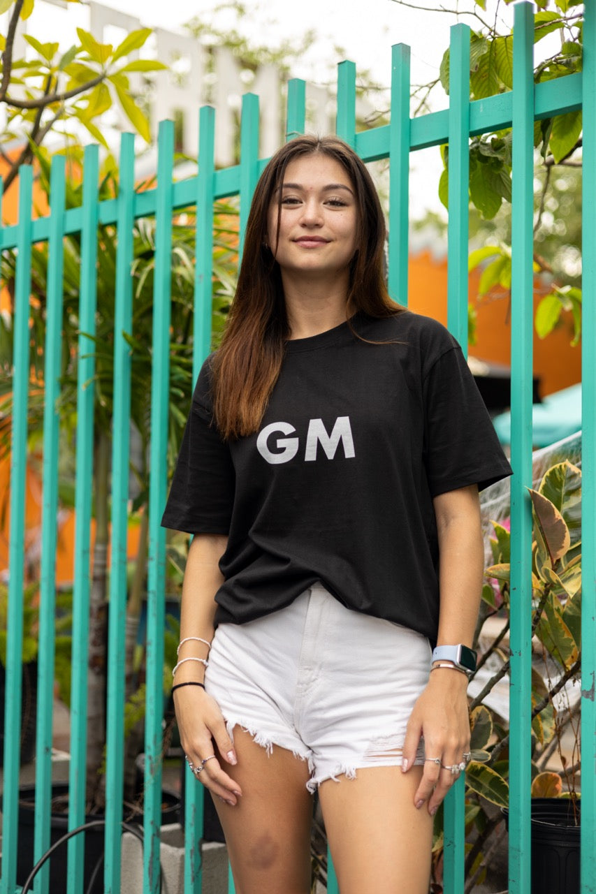 Hi GM Good Morning Internet Lingo Greeting T shirt in black, modeled by Dani Kott in Wynwood, Miami