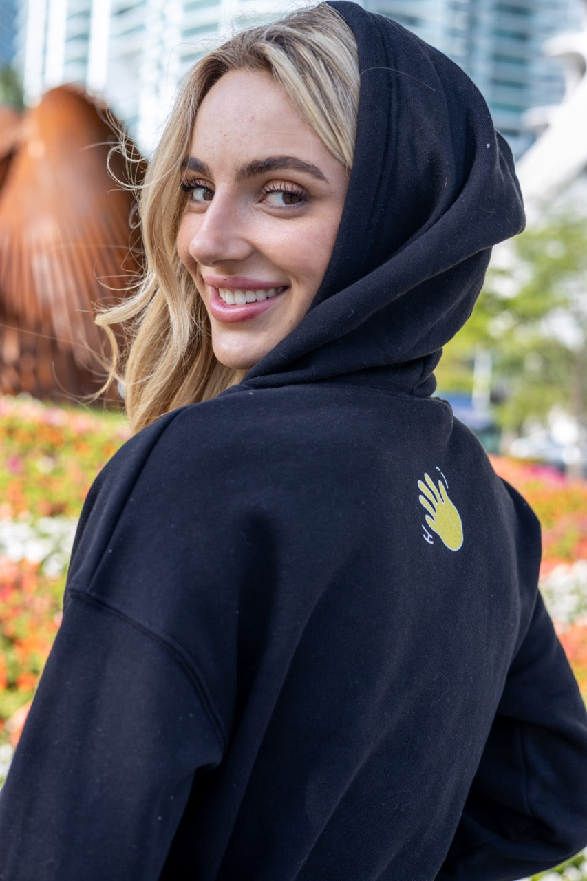 Hi 👋 Embroidered Cropped Hoodie in black modeled by Kara Gault photo by Johnny Michael