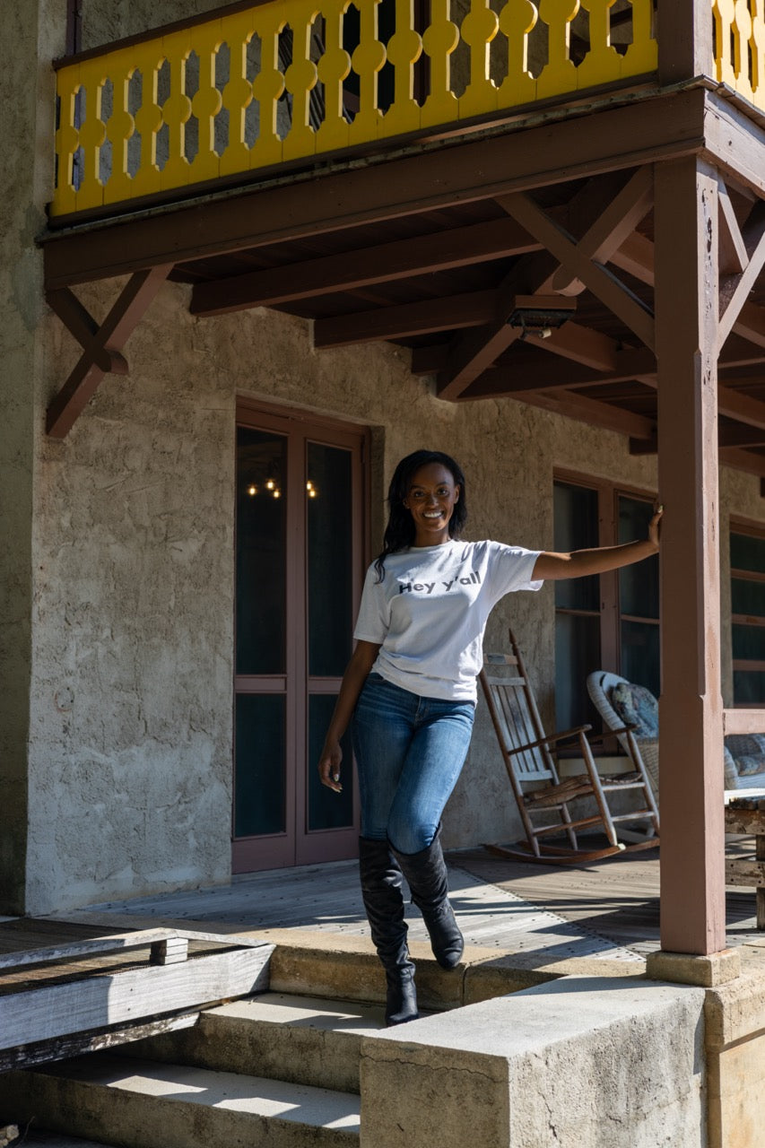 Hi Hey y'all Friendly Southern Greeting T shirt in white, modeled by Alyssa Ferguson at the Barnacle in Coconut Grove, Miami Florida