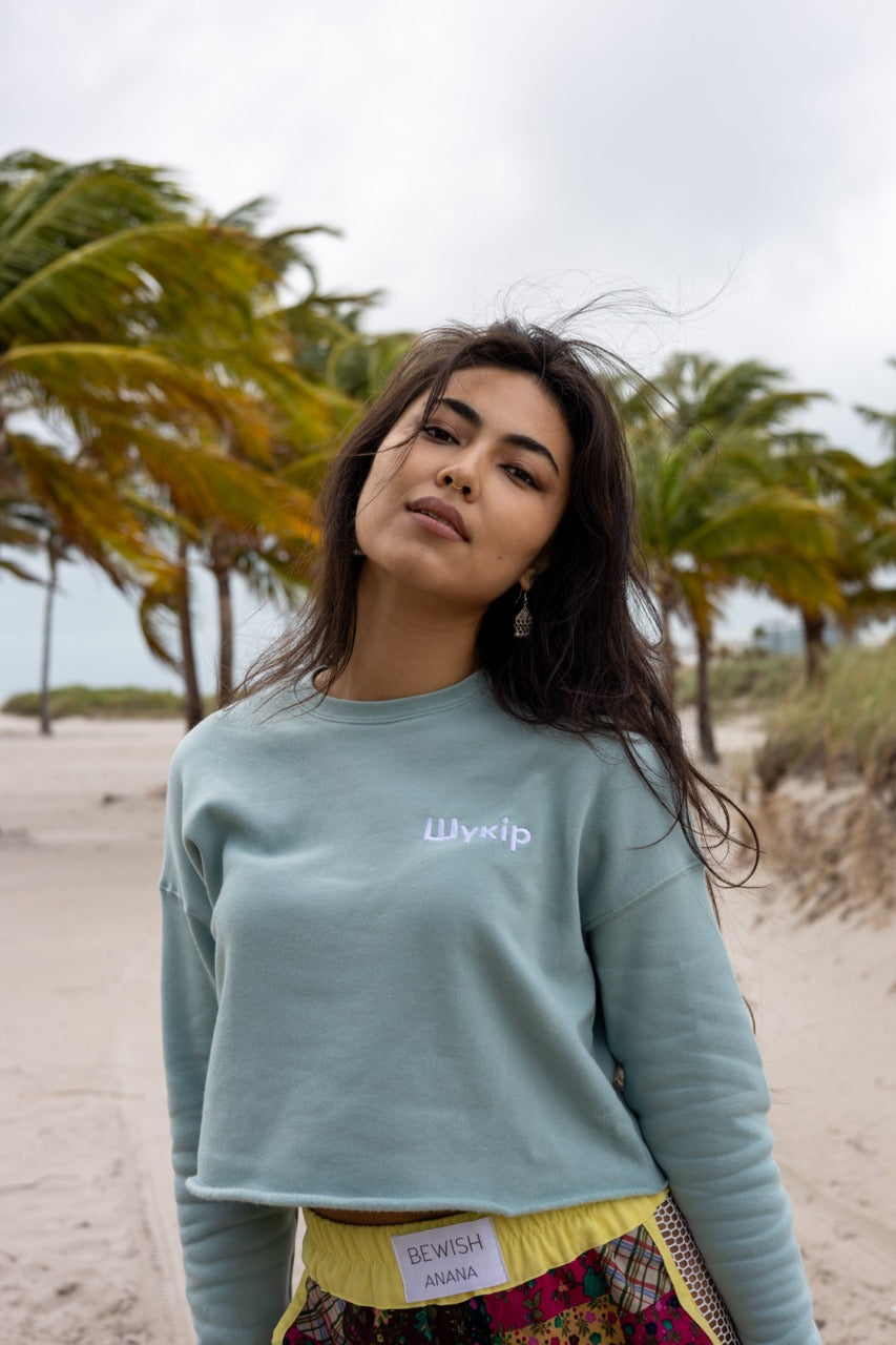 Hi Cropped Sweatshirt in light green, modeled by Assiya Mukanova in Key Biscayne, Miami, Florida