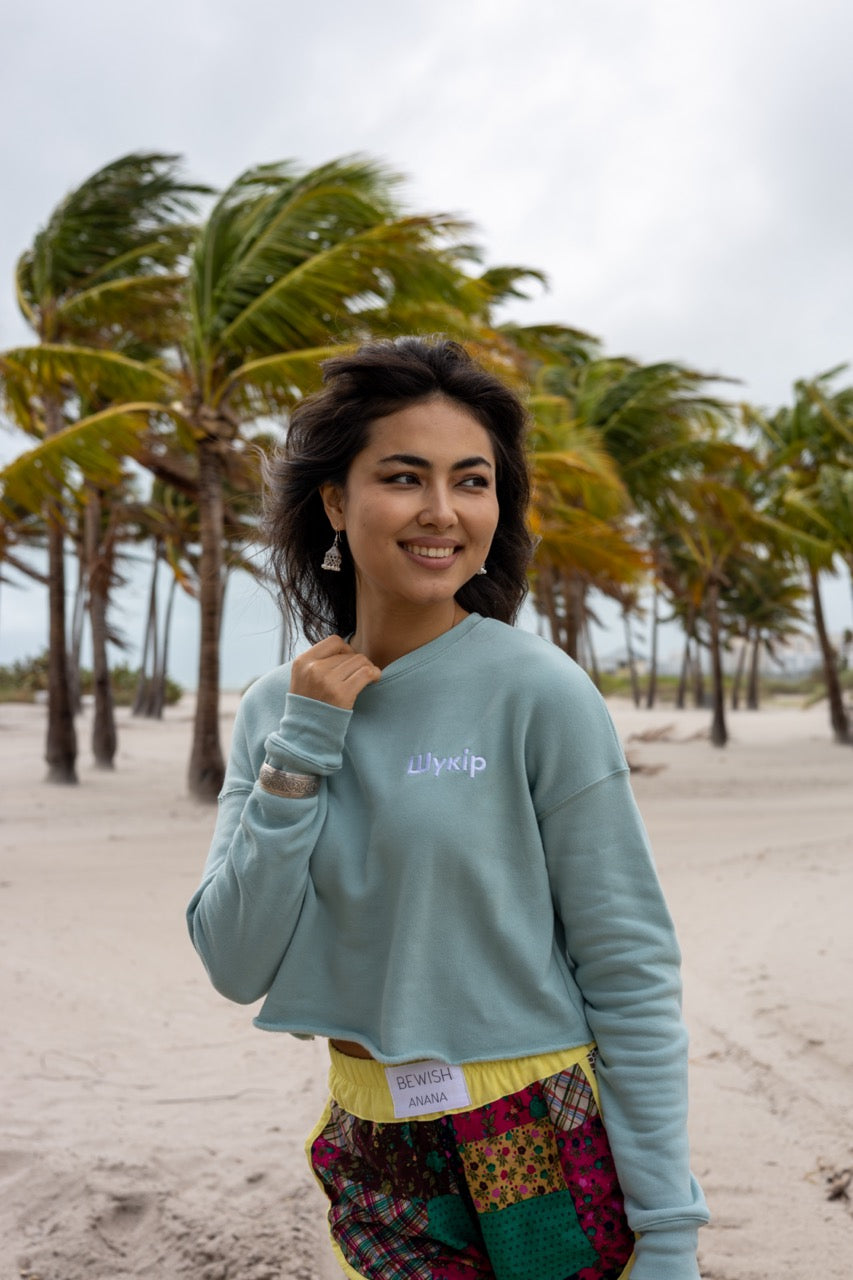 Hi Cropped Sweatshirt in light green, modeled by Assiya Mukanova in Key Biscayne, Miami, Florida