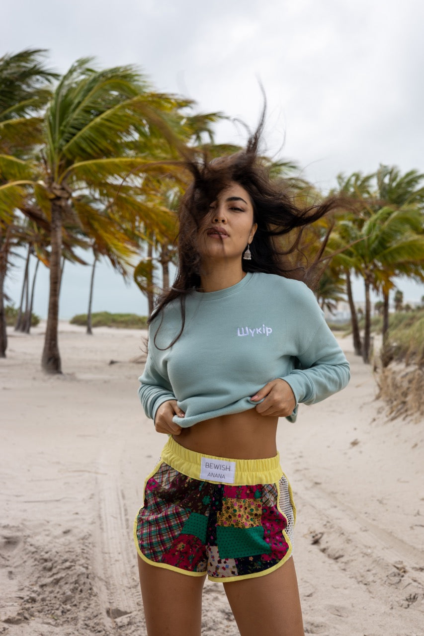 Hi Cropped Sweatshirt in light green, modeled by Assiya Mukanova in Key Biscayne, Miami, Florida