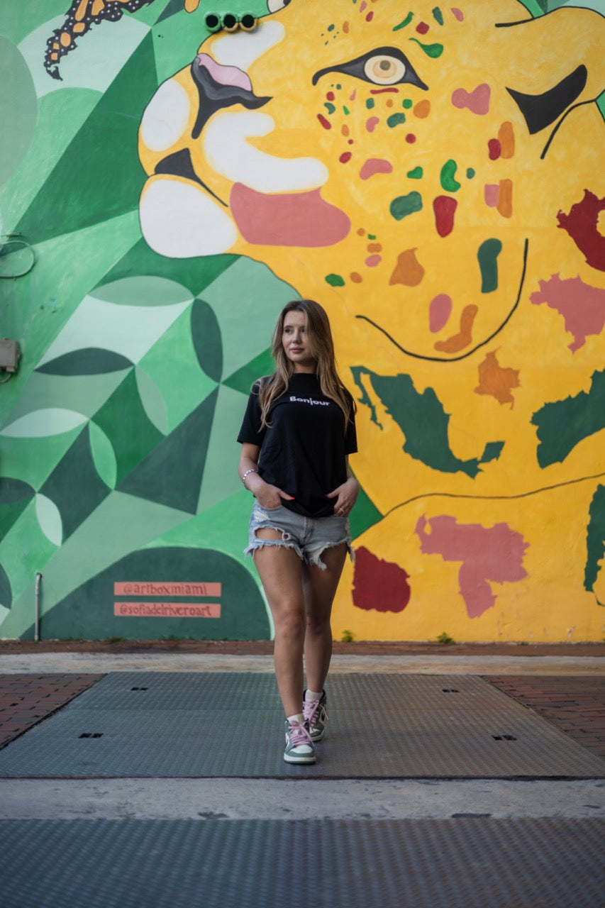 Alexandria LaChapelle models the Bonjour T Shirt for Happy interactions in black