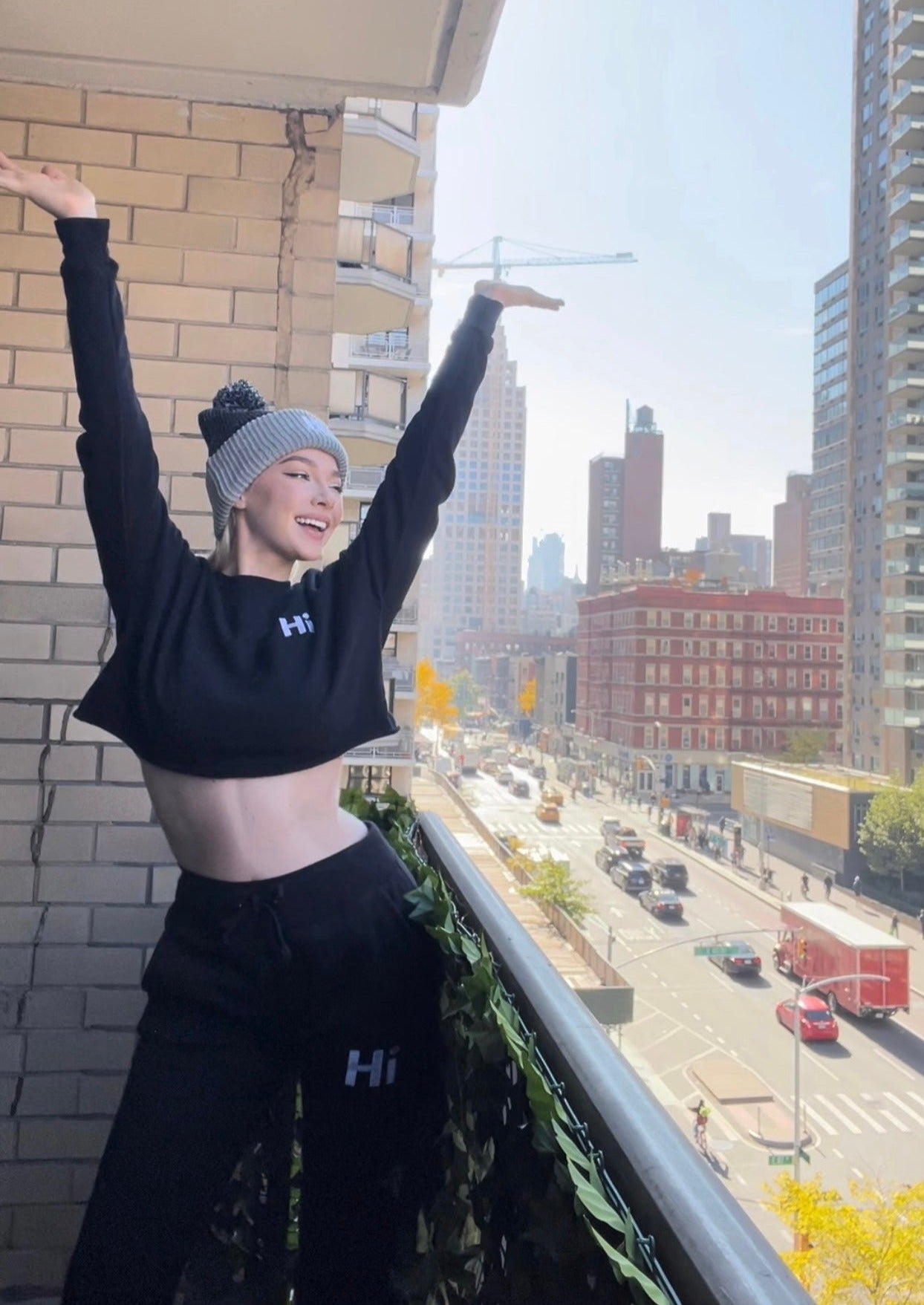 Shannon Milligan models the Hi Cropped Sweatshirt and the Hi Pom Pom Beanie and Hi Sweatpants for Happy interactions.