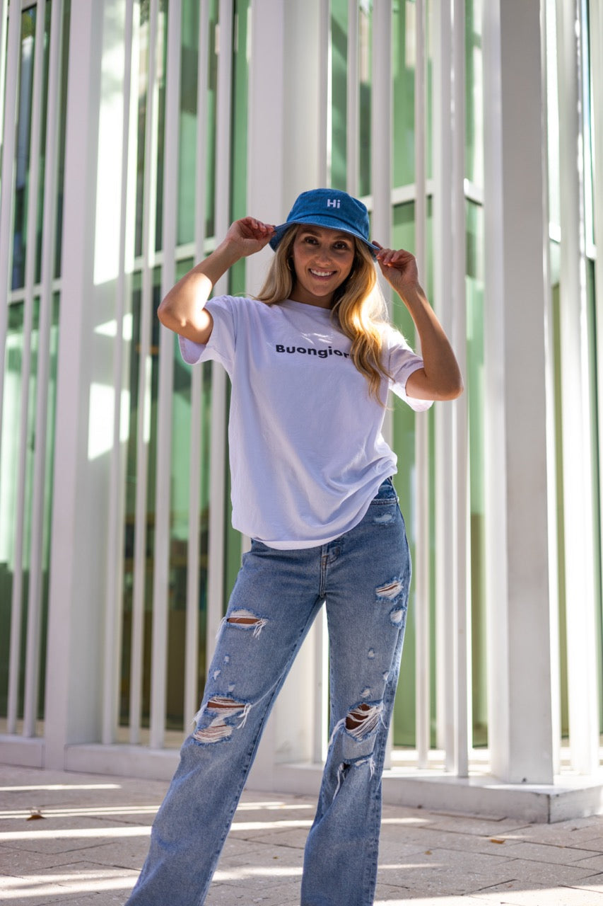 Alia Buoniello models the Hi Happy interactions Denim Bucket Hat in Light Blue Denim at the Miami Design District