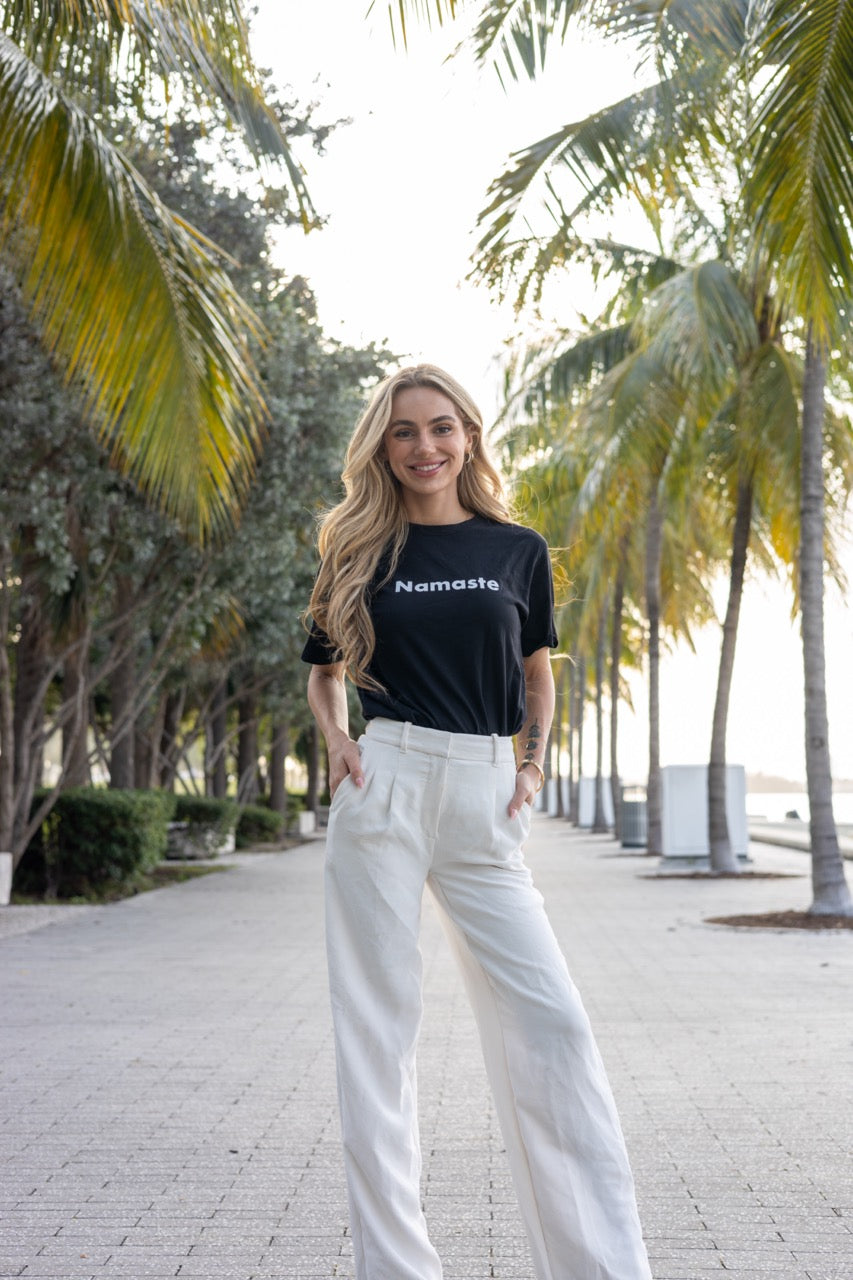 Hi Namaste Indian Greeting T Shirt in black, modeled by Kara Gault photographed by Johnny Michael at Maurice A. Ferré Park in Miami, Florida