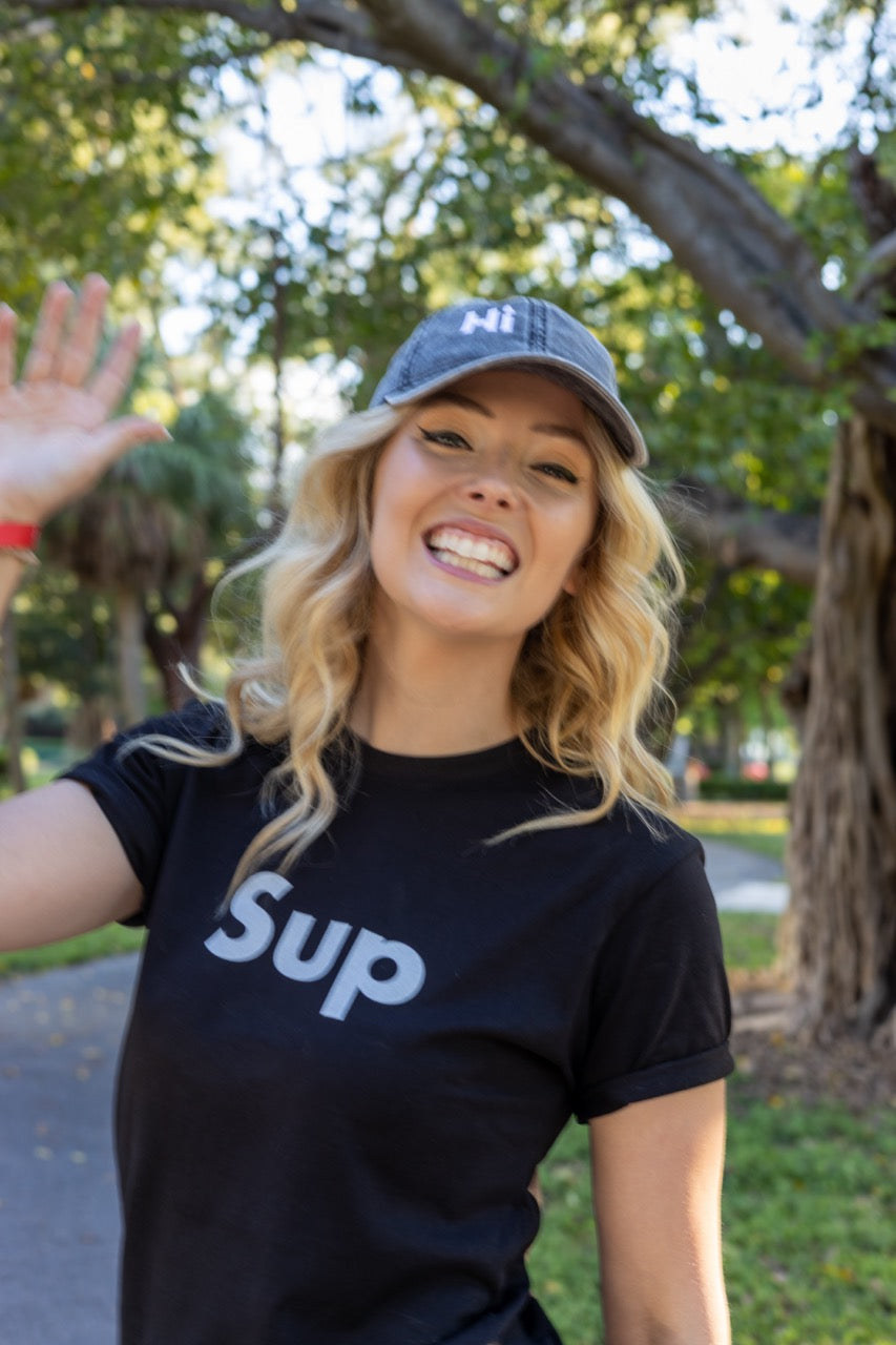 Hi and Yo Vintage Cap in charcoal grey, modeled by Jen Halvorson wearing the Sup Greeting T Shirt