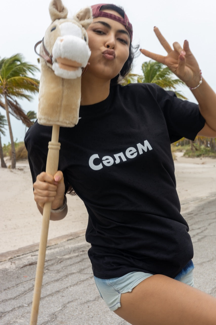 Hi in Kazakh Salem Greeting T Shirt in black, Сәлем written in Cyrillic script is pronounced "Salem", modeled by Assiya Mukanova