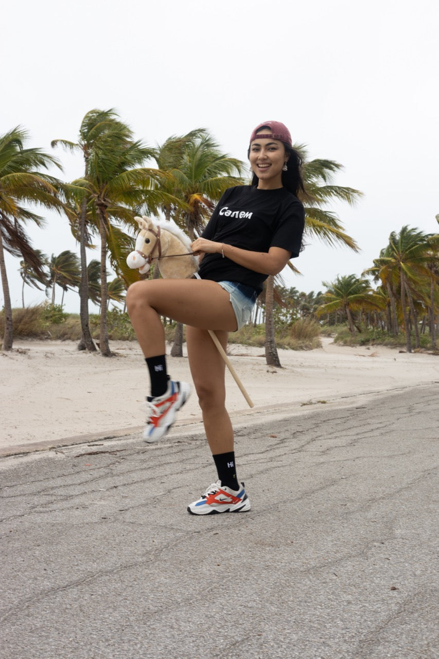 Hi in Kazakh Salem Greeting T Shirt in black, Сәлем written in Cyrillic script is pronounced "Salem", modeled by Assiya Mukanova
