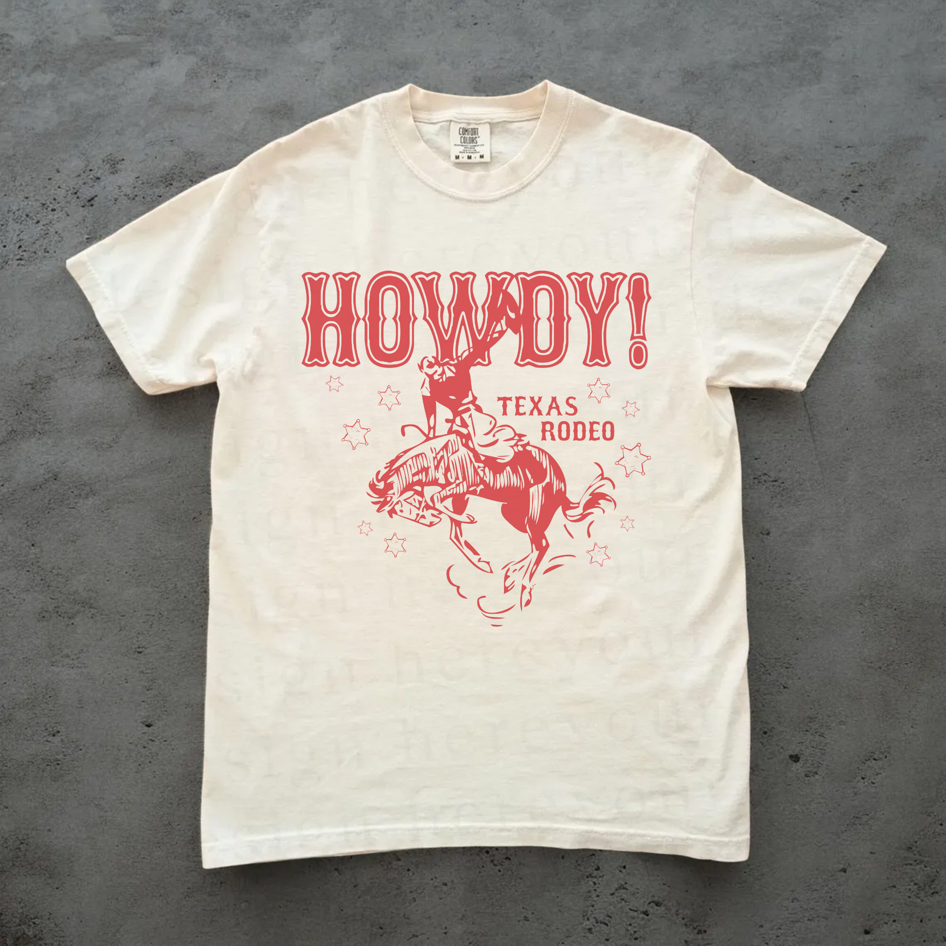 White t-shirt with red 'HOWDY! TEXAS RODEO' graphic on a gray background