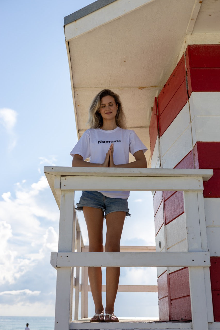 Hi Namaste Indian Greeting T Shirt in white, modeled by Claire photographed by Johnny Michael at Miami Beach South Pointe Park in Miami, Florida