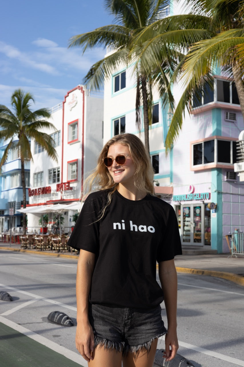 Hi Ni Hao Chinese Greeting T shirt in black, Ni Hao Hi Happy interactions modeled by Elli Scarborough and photography by Johnny Michael in South Beach, Miami