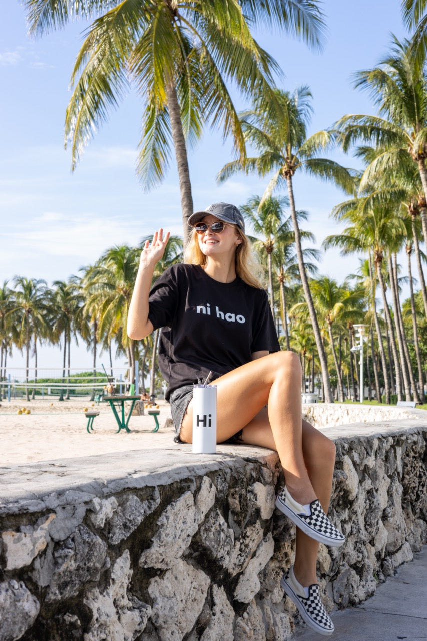 Hi Ni Hao Chinese Greeting T shirt in black, Ni Hao Hi Happy interactions modeled by Elli Scarborough and photography by Johnny Michael in South Beach, Miami