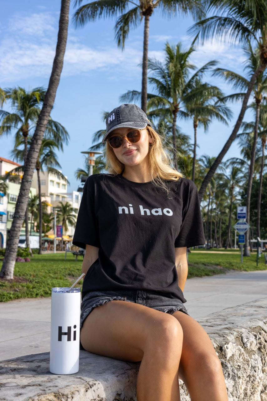 Hi Ni Hao Chinese Greeting T shirt in black, Ni Hao Hi Happy interactions modeled by Elli Scarborough and photography by Johnny Michael in South Beach, Miami