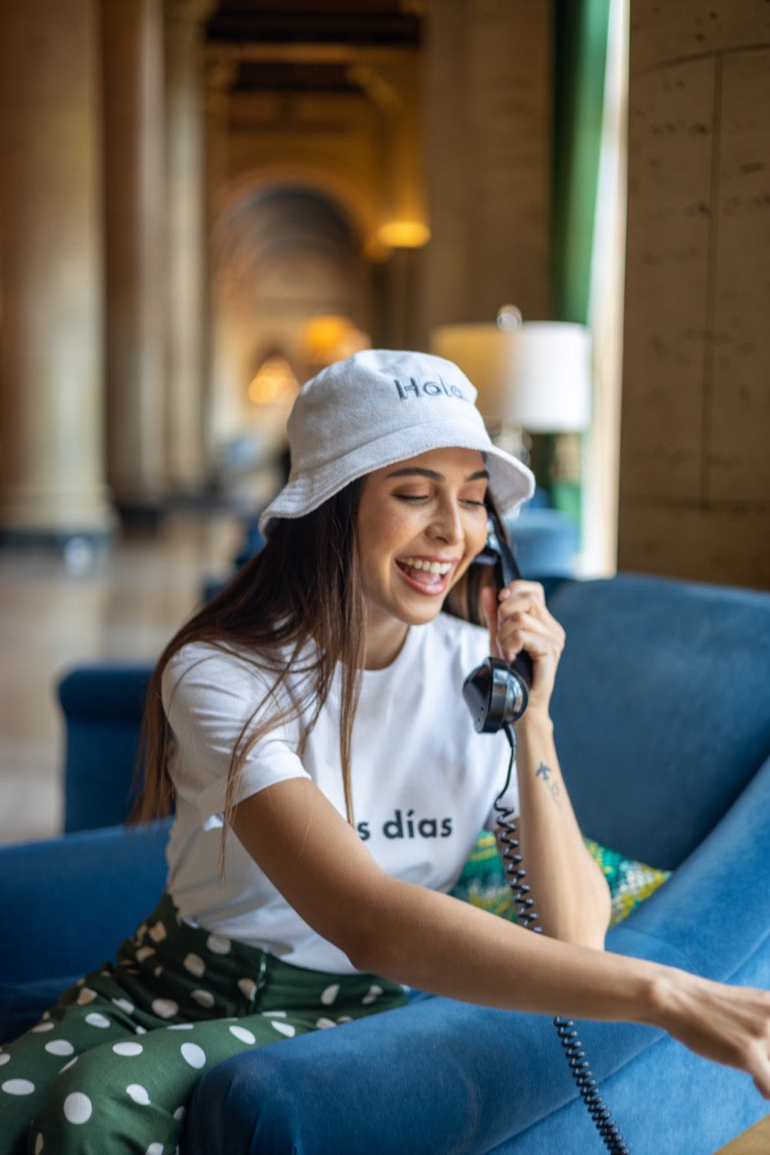 Rosa wears the Hi Hola Fuzzy Bucket Hat by Happy interactions at The Biltmore