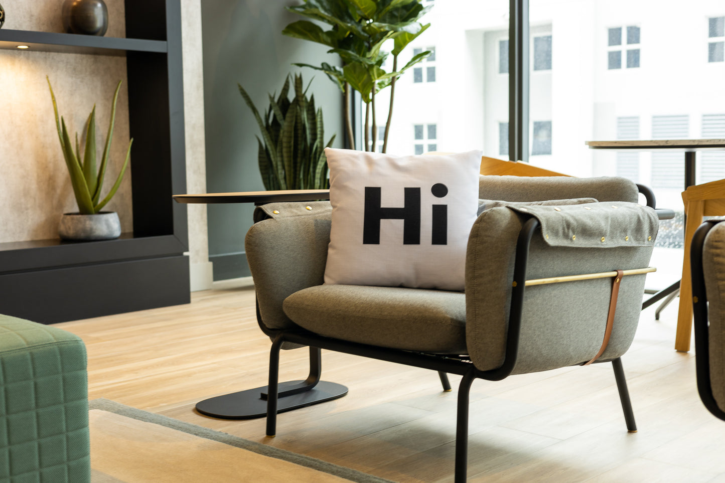 Hi Pillow by Hi Johnny in white in a building lounge space
