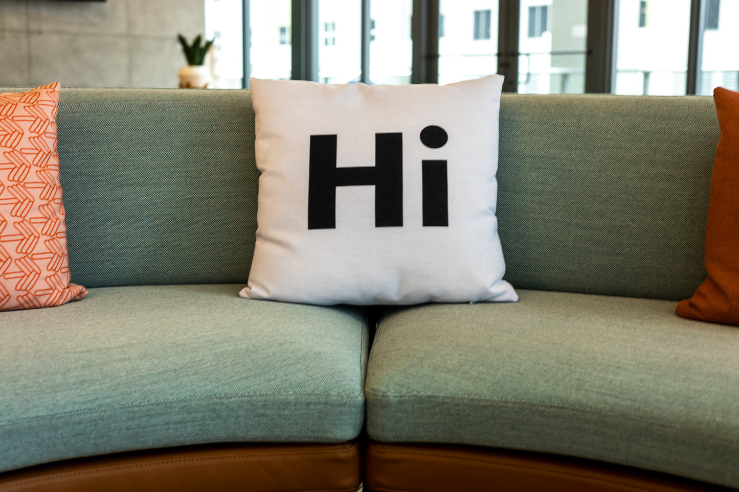 Hi Pillow by Hi Johnny in white in a coworking space lounge area