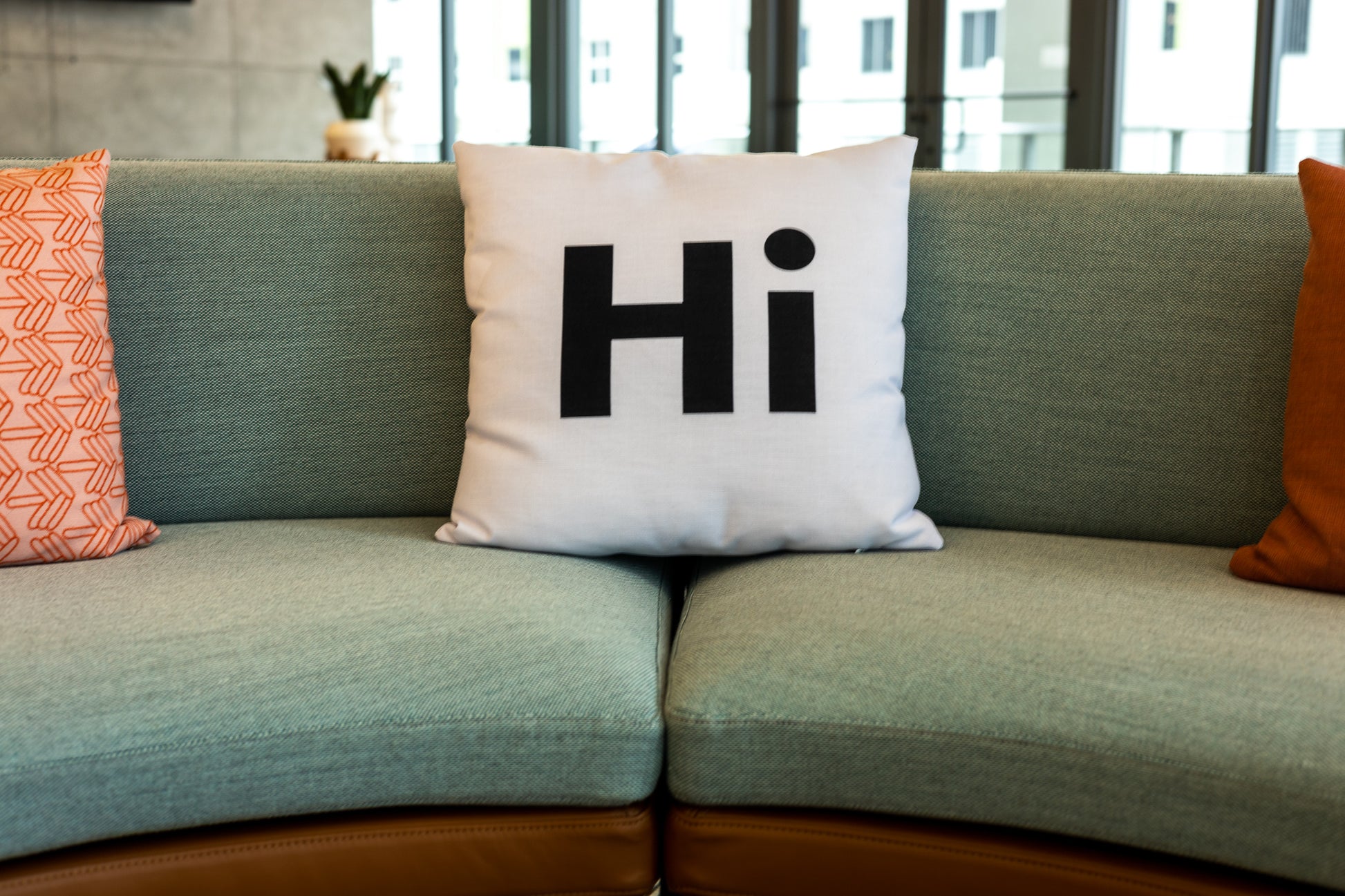 Hi Pillow by Hi Johnny in white in a coworking space lounge area