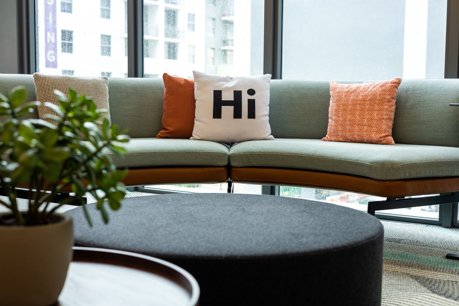 Hi Pillow by Hi Johnny in white in a coworking space lounge area